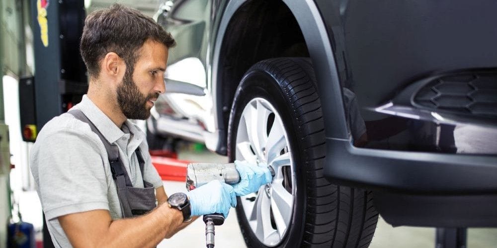 Mechanic replacing a tire.