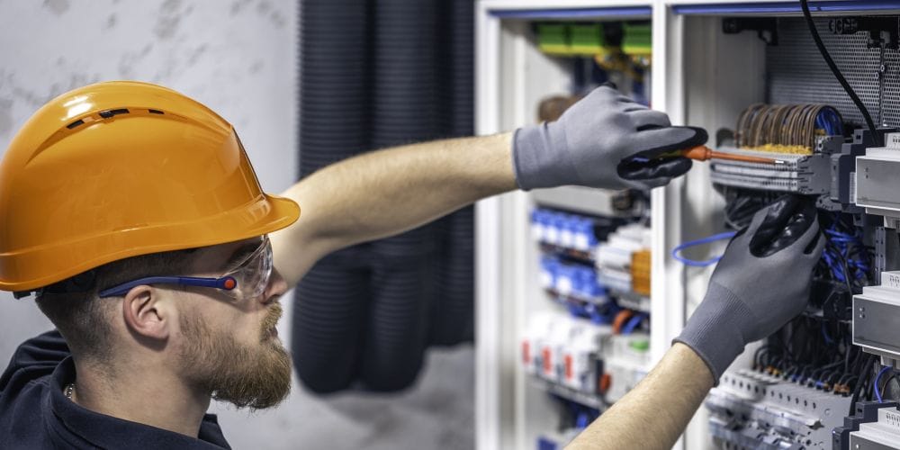 Electrician working on a circuit braker.