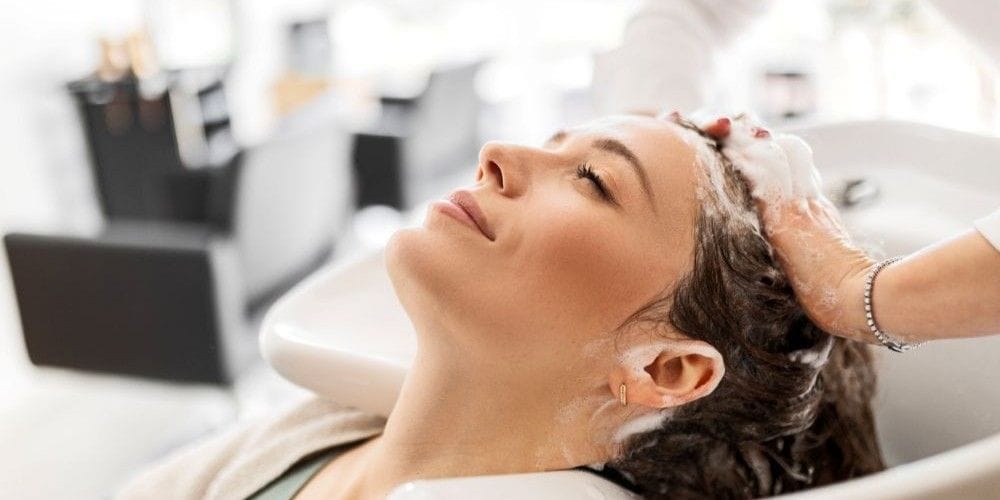 Woman getting her hair washed at a hair salon.