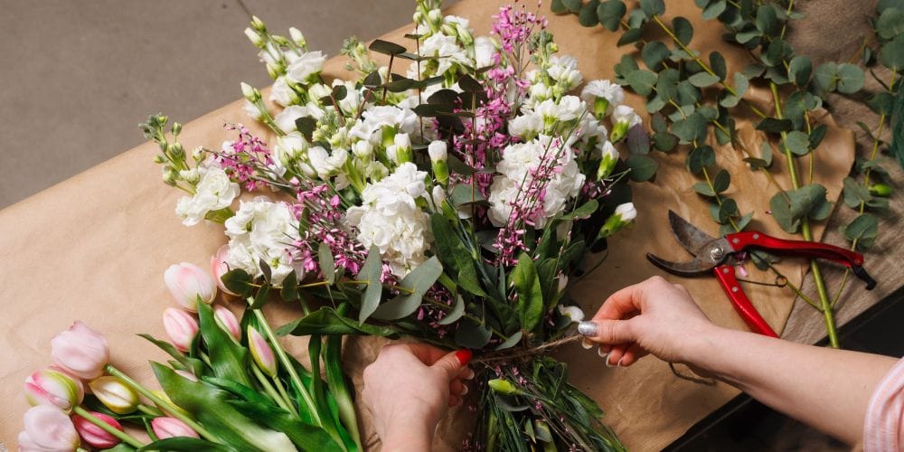 Florist creating a flower bouquet arrangement.