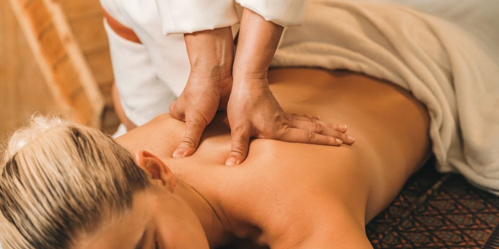 Woman receiving a massage at a spa.
